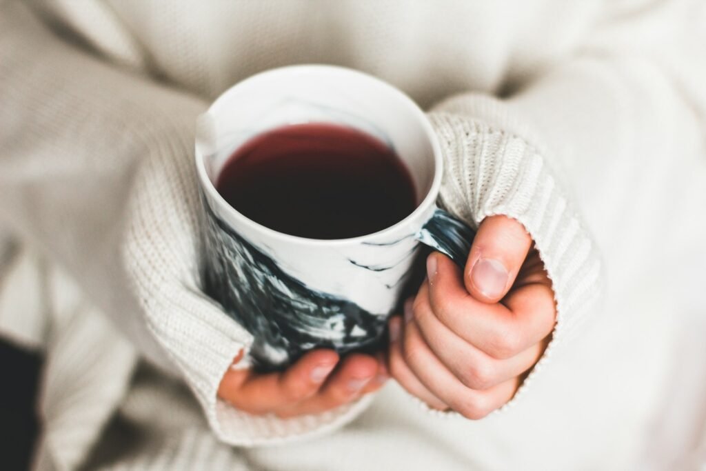 person holding cup of coffee heater issues furnace issues troubleshooting heater issues troubleshooting furnace issues